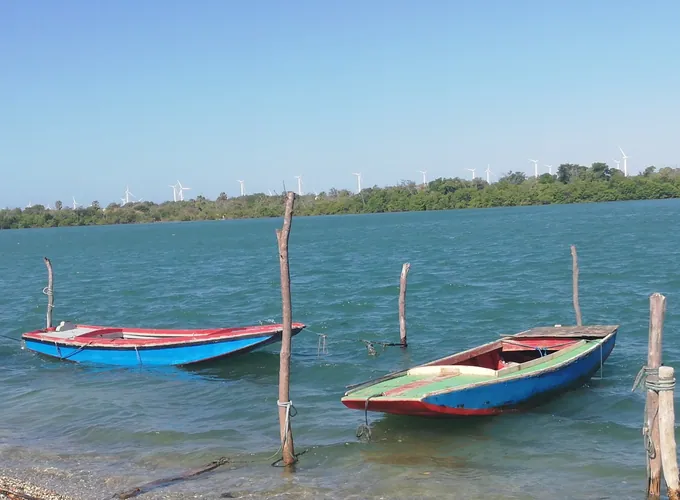 Pequenas embarcações junto à margem de conchas